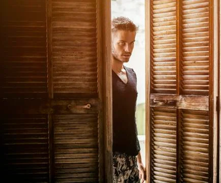 Handsome man walking in doors Stock Photos