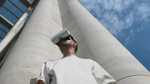 Handsome man wear virtual reality helmet or headset at modern architecture Stock Footage 170669140