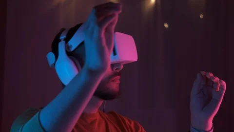 Handsome man wearing virtual reality headset. Augmented Reality. Shot on 4K Video stock 126586054
