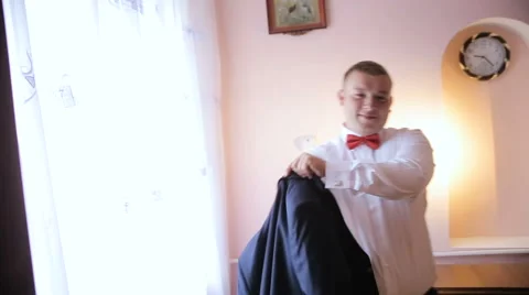 Handsome man wears a jacket Stock Footage 63624999
