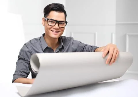 Handsome man while working on a project sitting behind a desk. Foto stock