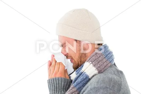 Handsome man in winter fashion blowing his nose Stock-Fotos