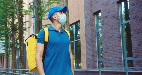 Handsome man worker with bachpack delivering food in business district. Youn Stock Footage 140112269