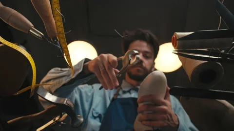 Handsome man, worker creates shoes. handmade, view through glass from bottom to Stock-Footage 140409476