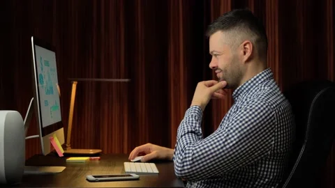 Handsome man working on desktop computer Stock Footage 166499493