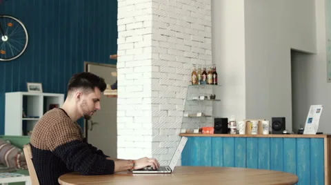 Handsome man working with laptop in cafe Stock Footage 62706387