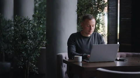 Handsome Man Working With Laptop In Cafe, Medium Portrait Shot, Work And Stock Footage 247412661