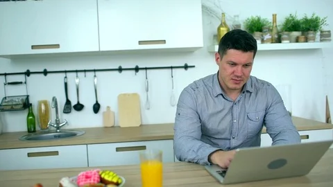 Handsome man working on laptop computer at home. slow-motion. Young businessman Stock Footage 83435751