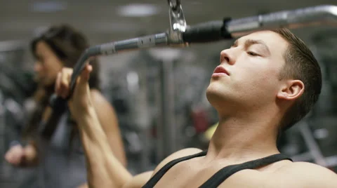 Handsome man working out in the gym doing lateral pulldowns Stock Footage 59715335