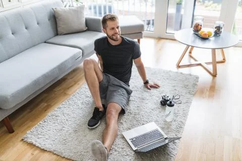 Handsome man working out at home Stock Photos