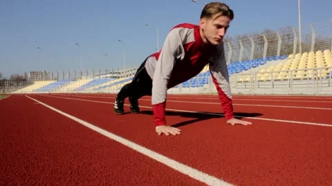 Handsome man working out on spring sunny day doing press push up sport exercise Stock Footage 137542663