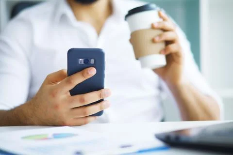 Handsome man working on project at modern office desk Stock Photos