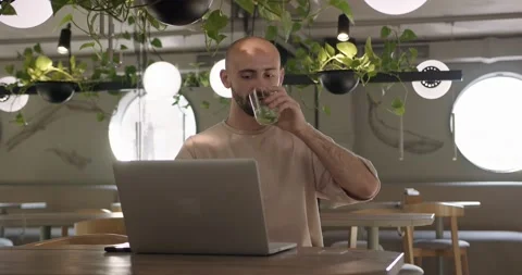 Handsome man working on wireless laptop at cafe Stock Footage 159083577
