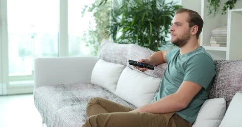 Handsome Man Zapping the Remote Control ... | Stock Video | Pond5