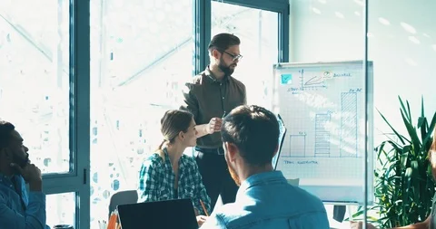 Handsome Manager making Presentation for his Colleagues at Clear Meeting Room. Stock Footage 120482741