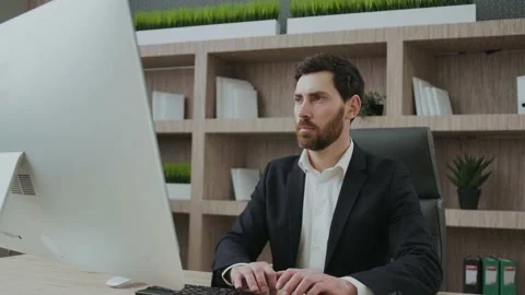 Handsome mature businessman using computer working online sitting in office Stock Footage 170622323