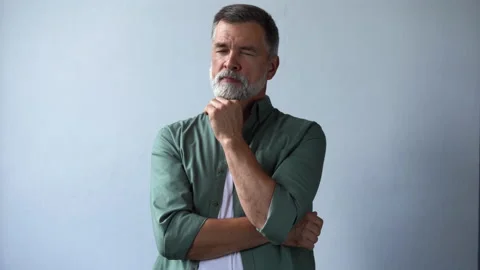 Handsome mature gray-haired man looking at camera, posing for video portrait Stock Footage 160463953