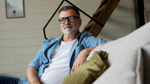 Handsome mature man looking at camera in modern home. Stock Footage 222128219