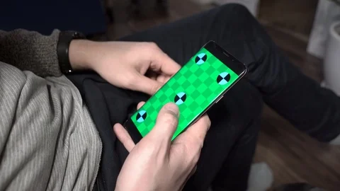 Handsome men at home using smartphone. Handsome men using digital display touch Stock Footage 102224837