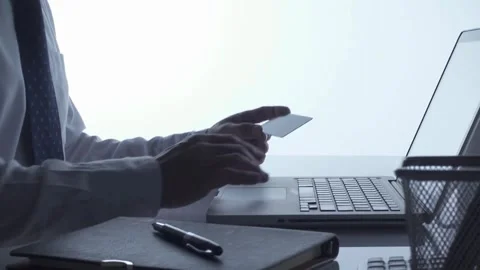 Handsome men is making online payment holding bank card using modern laptop Stock Footage 265931035