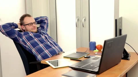 Handsome men sitting behind computer, he is happy Stock Footage 49058456