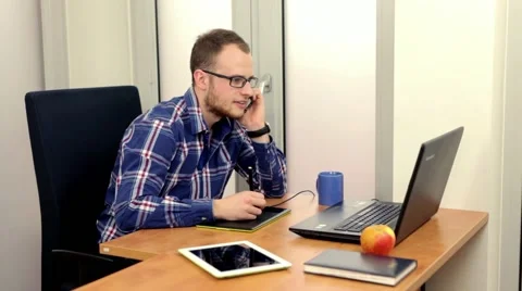 Handsome men sitting behind the desk and using computer. Stock Footage 49058005