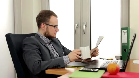 Handsome men sitting behind the desk. Negative emotion Stock Footage 49340868
