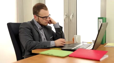 Handsome men sitting behind the desk with laptop. Stock Footage 49341136