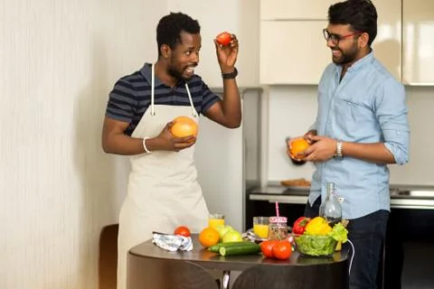 Handsome men standing in kitchen Stock Photos
