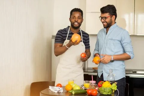 Handsome men standing in kitchen Stock Photos