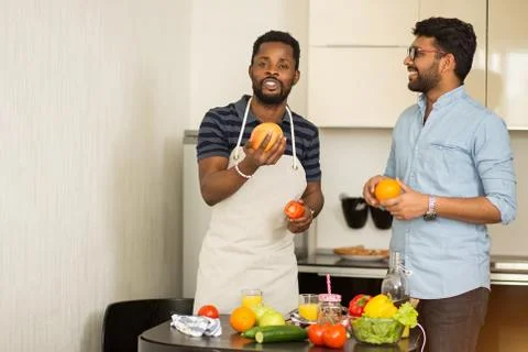 Handsome men standing in kitchen Stock Photos