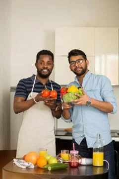 Handsome men standing in kitchen Stock Photos