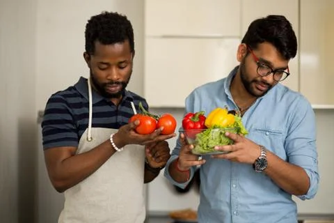 Handsome men standing in kitchen Stock Photos