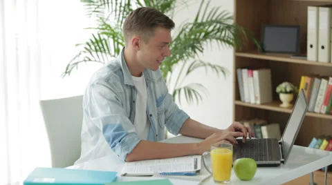 Handsome men using laptop and drinking juice Video stock 27692083