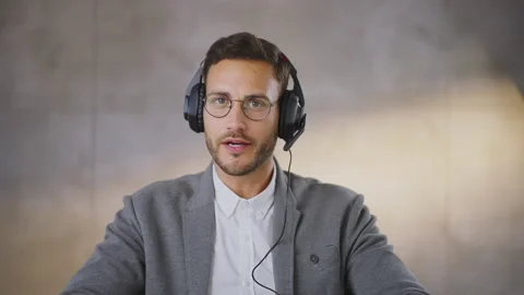 Handsome mid age man speaking to business partner. Using modern online Stock Footage 164487066