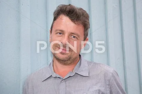 Handsome middle age man with gray hair in an outdoor setting. Stock Photos