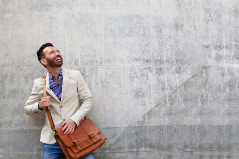 Handsome middle aged guy standing against wall Stock Photos