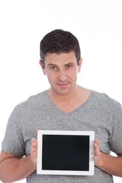Handsome middle-aged man displaying a tablet Stock Photos