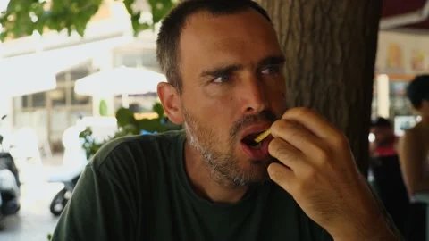 A handsome middle-aged man eats French Stock Video Pond5