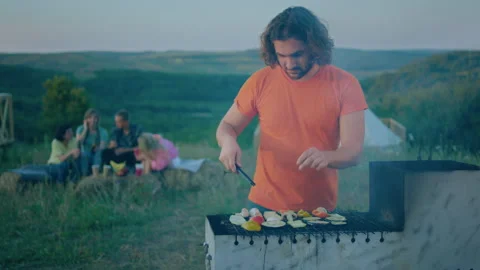 A handsome middle aged man is flipping over vegetables as he is cooking them on Stock Footage 243112821