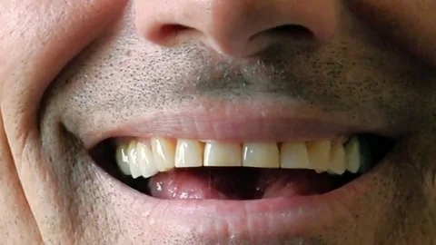 Handsome middle-aged man laughs: very closeup footage On His mouth Video stock 73167349