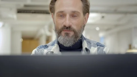 Handsome middle aged man look at laptop and smile 스톡 동영상 121805003