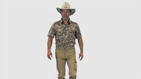 Handsome middle aged man ranger walks in camouflage and cowboy hat, alpha Video stock 306026254