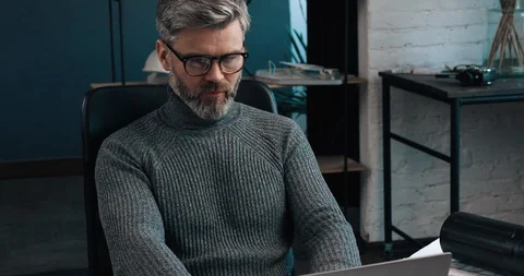 Handsome Middle aged Man working like Architect at his Office, typing on Video stock 126243967