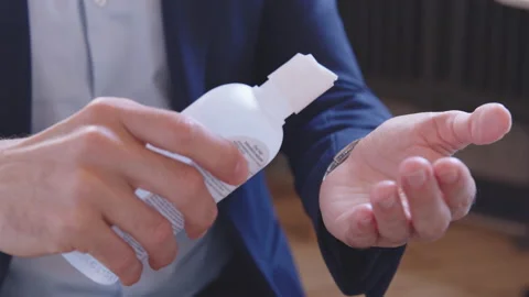 Handsome middle-eastern man using liquid hand sanitizer during quarantine. Stock Footage 136547764