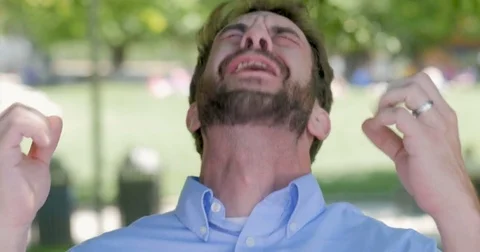 Handsome millennial man in 30s with beard surprised to hear he just won Video stock 81137997