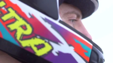 Handsome motorcycle driver puting on his helmet. Close up. Stock Footage 73655937
