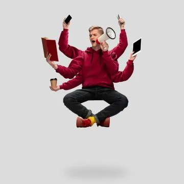 Handsome multi-armed student levitating isolated on grey studio background with Stock Photos