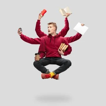 Handsome multi-armed student levitating isolated on grey studio background with Stock Photos