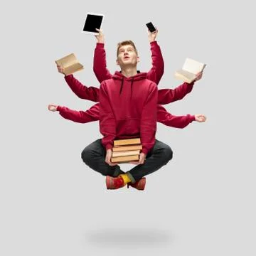 Handsome multi-armed student levitating isolated on grey studio background with Stock Photos